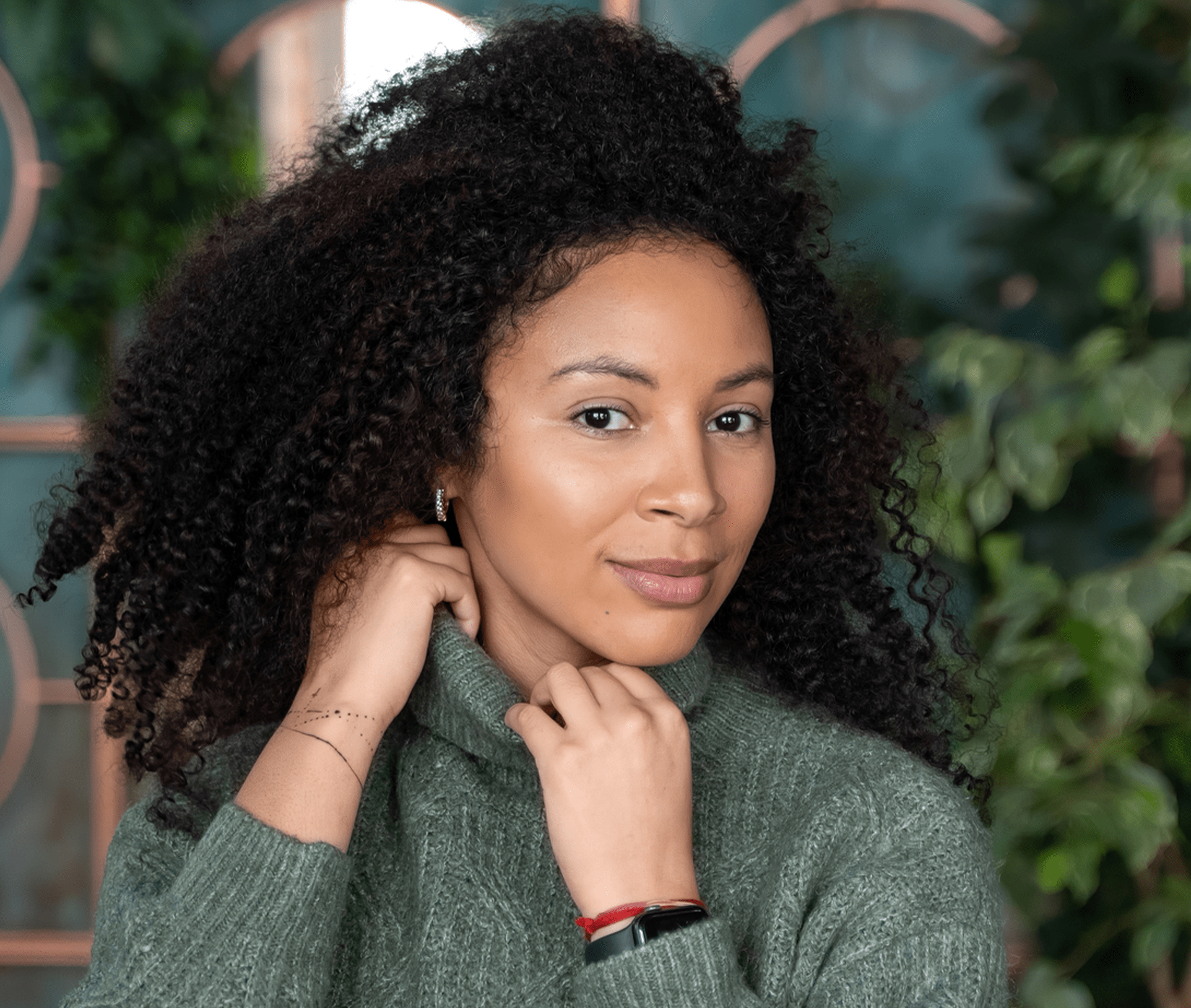 woman grabbing her turtle neck sweater